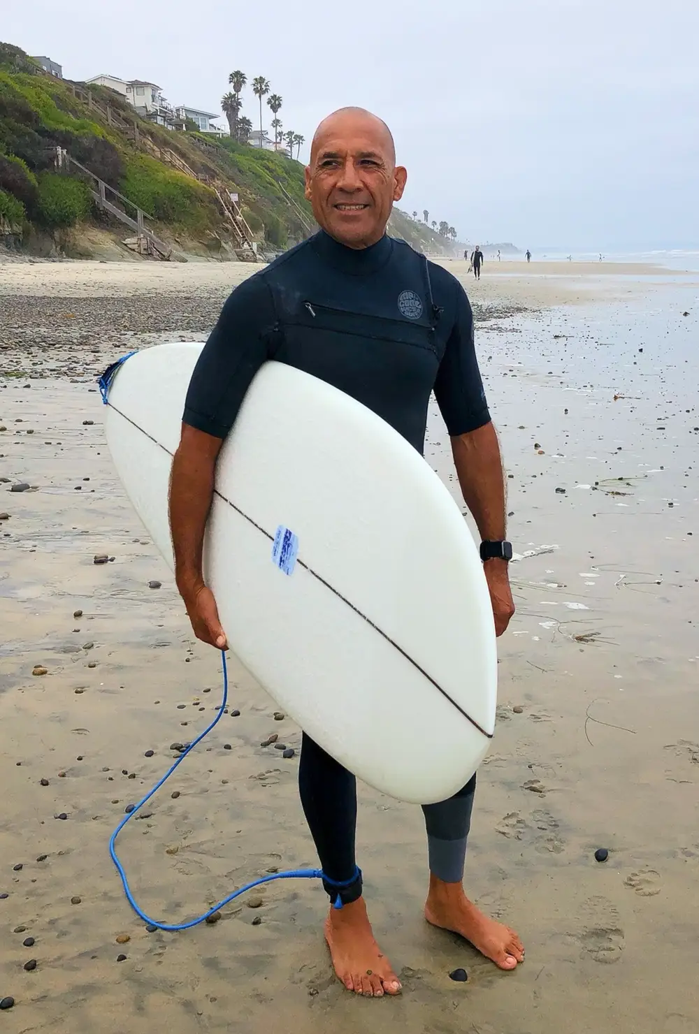 man in black and white t-shirt and black shorts sitting on green grass field during